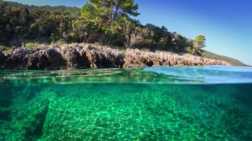 Magnificent clear water in the Adriatic Sea. Dome underwater shot, slow motion. Camera slowly sinks into transparent sea water. Adriatic sea - top popular tourist destination