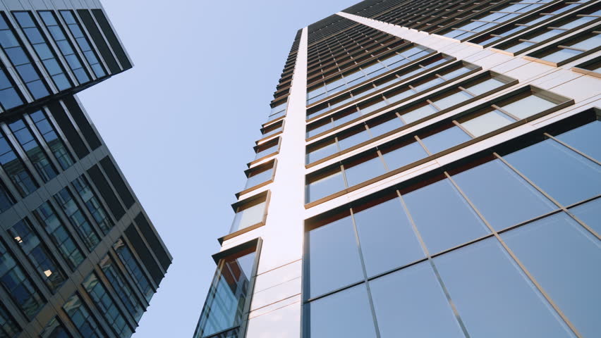 Looking up city downtown skyscrapers, modern high-rise office buildings in financial district. Business center architecture, wide angle dolly shot, glass skyscraper view from below, cinematic gimbal