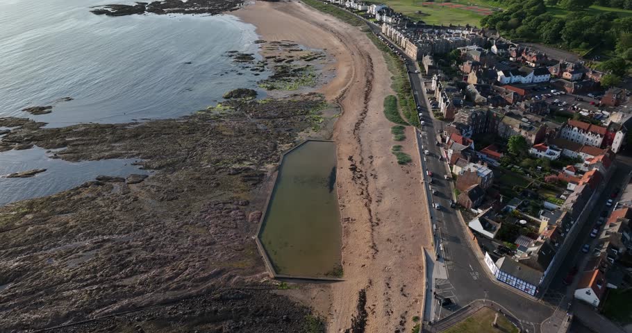 Aerial view of the beautiful harbour and beach with boats and residential buildings, North Berwick, United Kingdom.