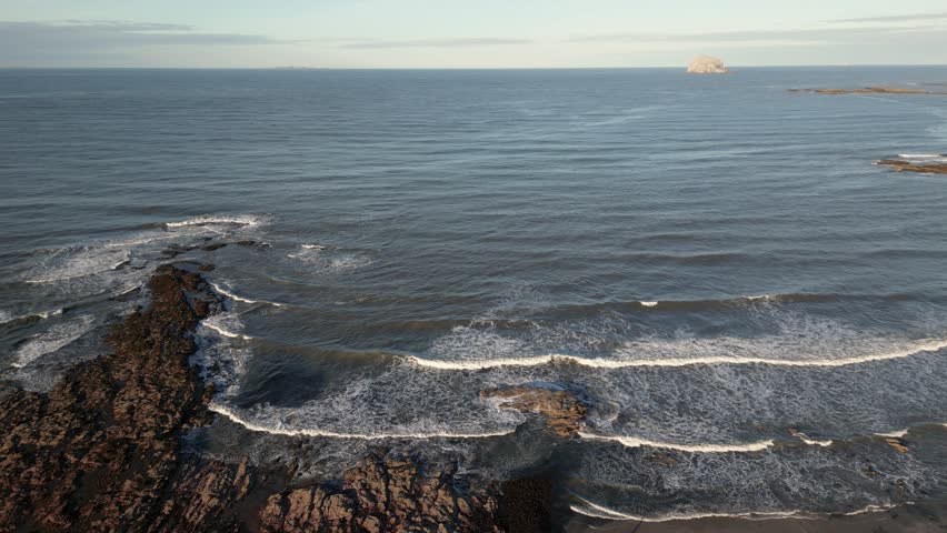 Aerial view of tranquil East Beach with beautiful coastline and rocky shore, North Berwick, Scotland.