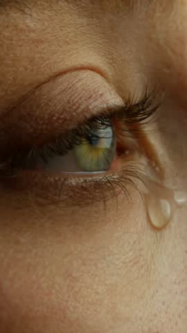 A Tear Running Down a Young Beautiful Woman Face, Macro