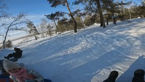 POV shot of snow tubing down hill in winter forest with little friends, children doing fun activity on winter vacations - Powered by Shutterstock - Get 15% off with code: PIKWIZARD15