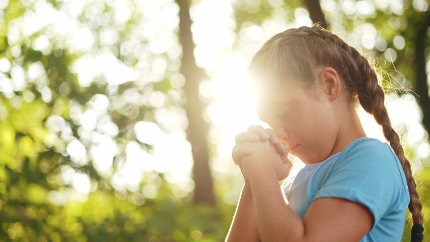 child pray. young gratitude a god religion concept. little girl in nature outdoors lifestyle praying dreams of happiness to god. praise worship freedom concept. kid praying in the forest
