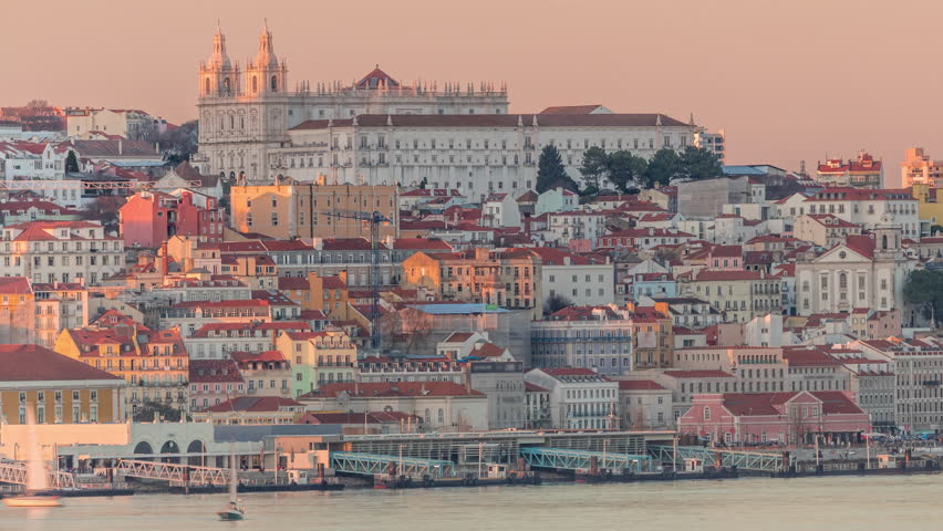 Panorama of Lisbon historical center and ferry terminal Terreiro do Paco aerial timelapse during sunset from above. Portugal