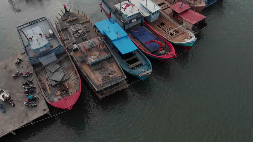 Aerial view of a beautiful harbour with docked fishing boats and calm water, Tanjung Pandan, Indonesia.