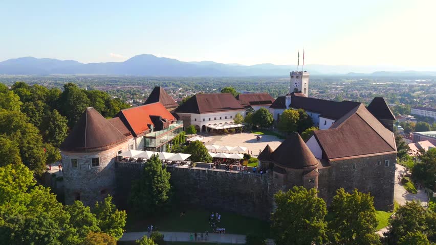 Stunning drone footage of Ljubljana, Slovenia, showcasing the charming old town, the medieval castle, and the vibrant city center with its picturesque streets and unique architecture.