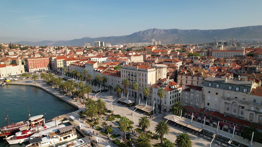 Aerial view of Split in Croatia. Riva promenade, famous travel destination in Split, establishing shot. Old town with historical red roof tiled buildings, Adriatic Sea