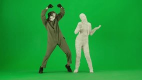 Portrait of person in a mummy bandage on chroma key green screen background. Maniac and mummy dancing - Powered by Shutterstock - Get 15% off with code: PIKWIZARD15