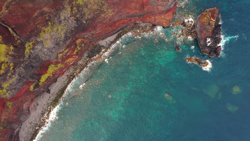 Aerial view of the beautiful rugged coastline with turquoise ocean and craggy rocks, Azores, Portugal.