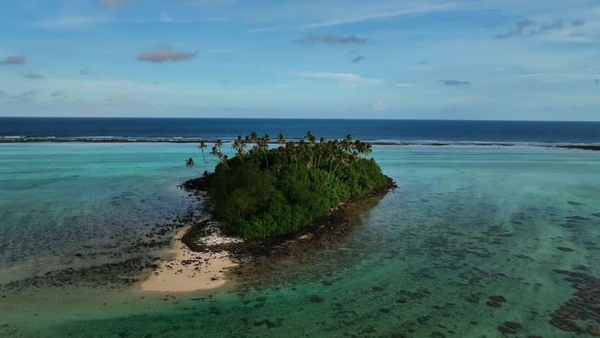 Aerial view of a beautiful tropical island with clear turquoise ocean and lush palm trees, Rarotonga, Cook Islands.