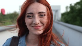 Close-up shot of a young woman's face, highlighting her green eyes and natural red hair in soft lighting. Close-Up of Woman's Eyes with Red Hair - Powered by Shutterstock - Get 15% off with code: PIKWIZARD15