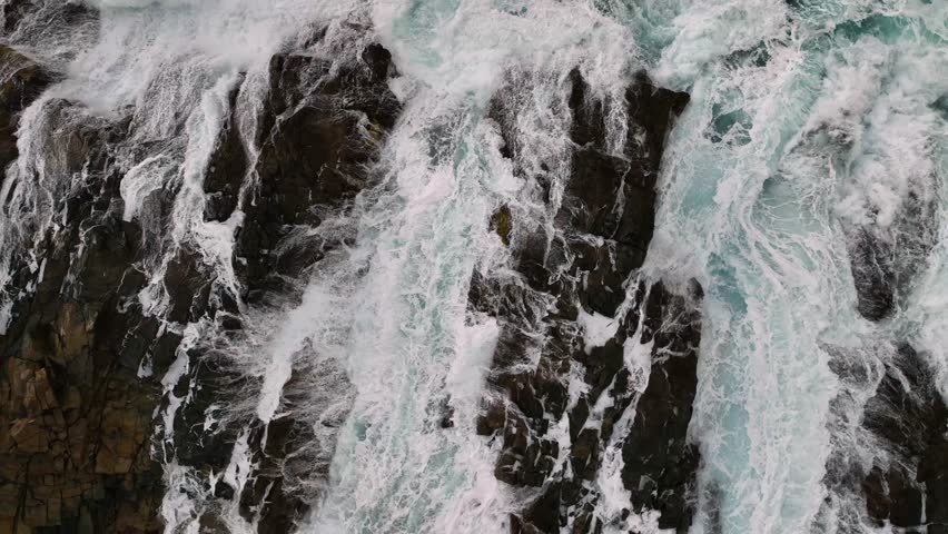 Aerial view of dramatic cliffs and crashing waves along the coastline, Santa Cruz de Tenerife, Spain.