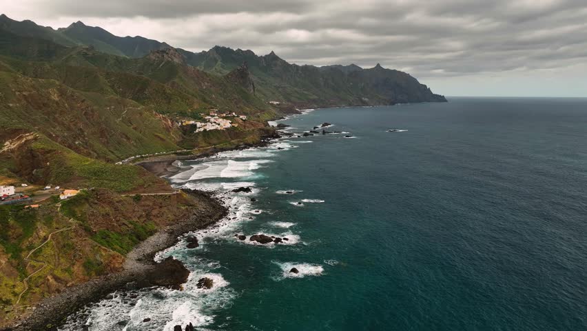 Aerial view of rugged cliffs and tranquil waves along the coastline, Santa Cruz de Tenerife, Spain.