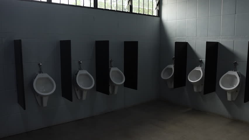 Urinals in mens bathroom on sunny day