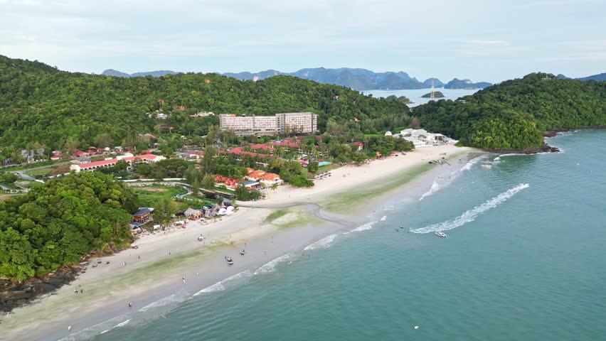 Aerial view of pantai tengah beach with a beautiful resort and lush greenery, Kuah, Malaysia.