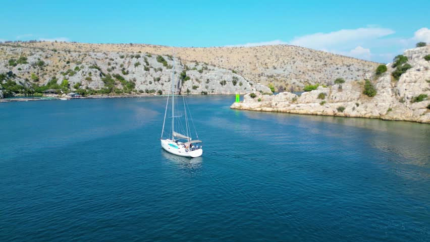 An aerial view of the stunning Krka Canyon located between Šibenik and Bilice in Croatia. The canyon winds through lush landscapes and dramatic cliffs, with the Krka River 