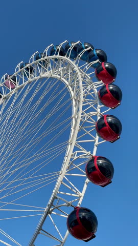Experience breathtaking views from a colorful Ferris wheel on a sunny afternoon