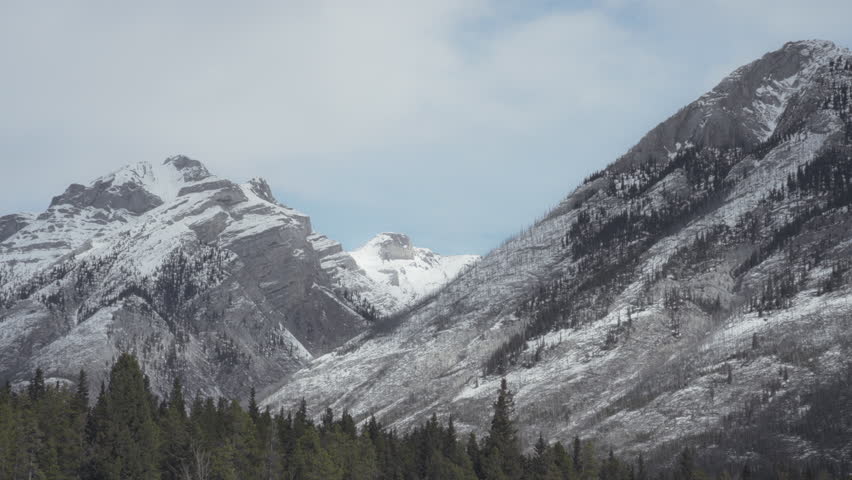 Snowy peaks of rocky mountain range in Banff National Park, Canada. Slow motion. 