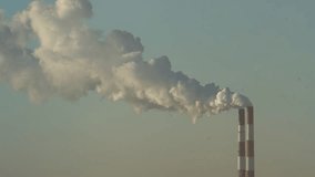 The two chimneys of the power plant give off white puffs of smoke, pollution of the atmosphere. Global warming Man's Carbon Footprint. Electricity production with fossil fuel concept. Polluting - Powered by Shutterstock - Get 15% off with code: PIKWIZARD15