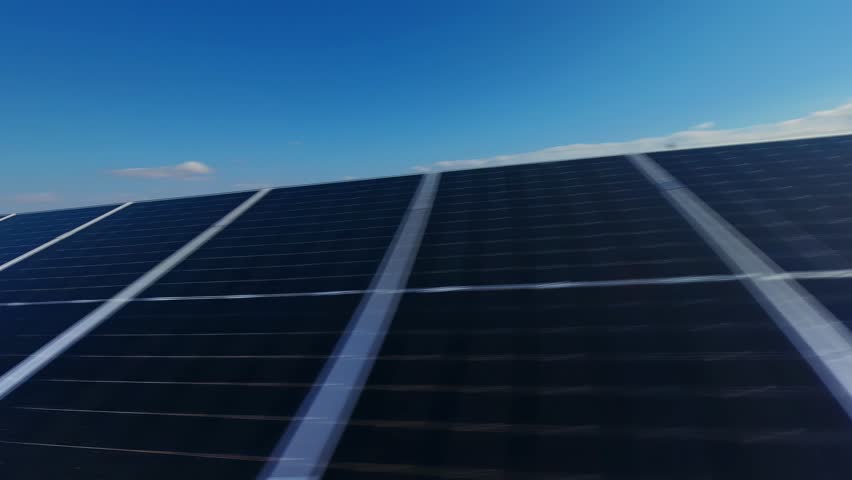 A stunning FPV drone flight gliding smoothly over solar panels, capturing the essence of renewable energy from a unique perspective.