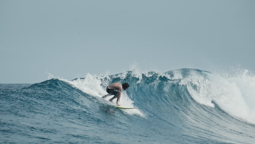 Beginner surfer learns take off on big waves
