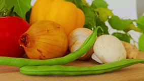 vegetables on wooden table, red tomato, yellow pepper, white button mushrooms, white onion, green string beans, green foliage background, landscape, perfect for background

 - Powered by Shutterstock - Get 15% off with code: PIKWIZARD15