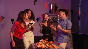 Asian friends, including a middle-aged man and a young woman, enjoy an office party with RGB lights, fried chicken, grilled food, hamburgers, grape wine, and champagne, celebrating together at night. - Powered by Shutterstock - Get 15% off with code: PIKWIZARD15