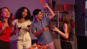 Asian friends, including a middle-aged man and a young woman, enjoy an office party with RGB lights, fried chicken, grilled food, hamburgers, grape wine, and champagne, celebrating together at night. - Powered by Shutterstock - Get 15% off with code: PIKWIZARD15