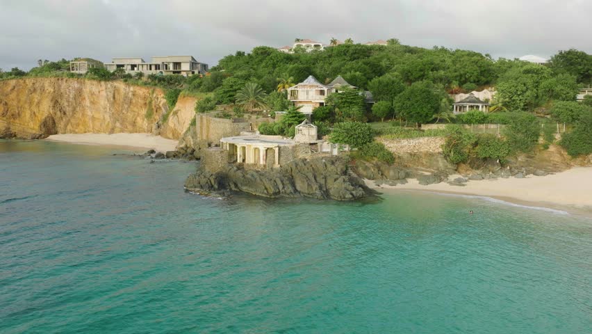 Pan drone shot of Baie rouge beach pavilion situated at bay of sea in Saint Martin.