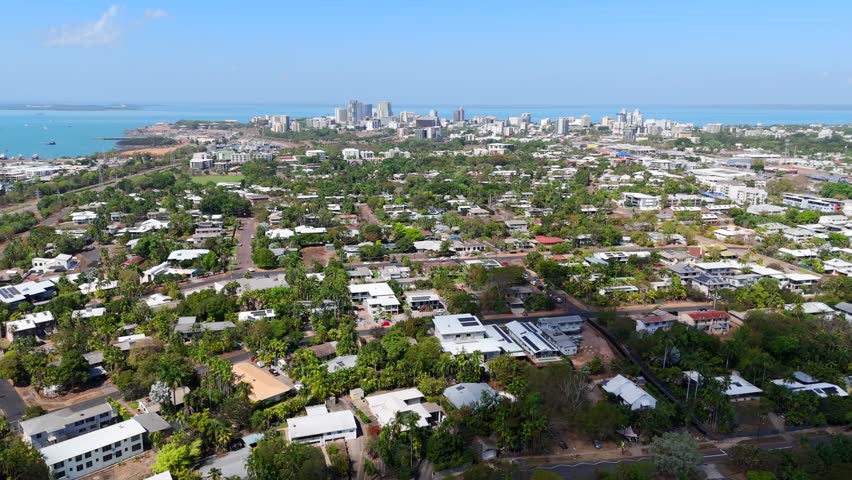 Aerial view of Darwin City from residential neighborhoods to the coast, showcasing urban and coastal landscapes