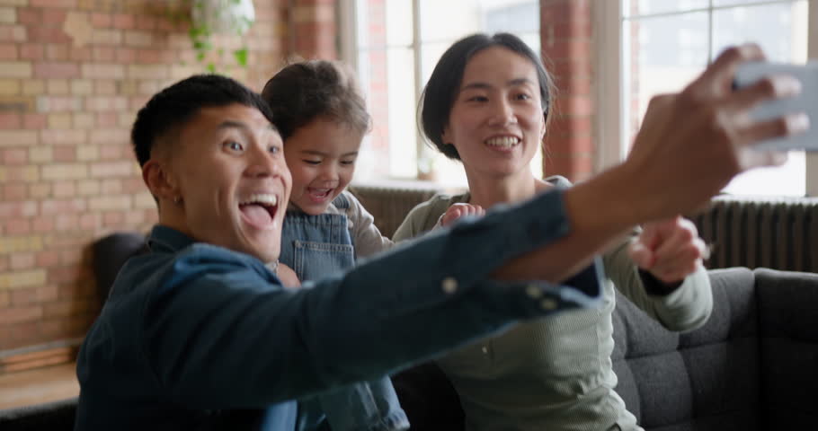 Asian Family taking Selfie using Smart phone