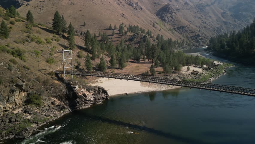 Aerial above bridge on Salmon River in mountains near Riggins Idaho