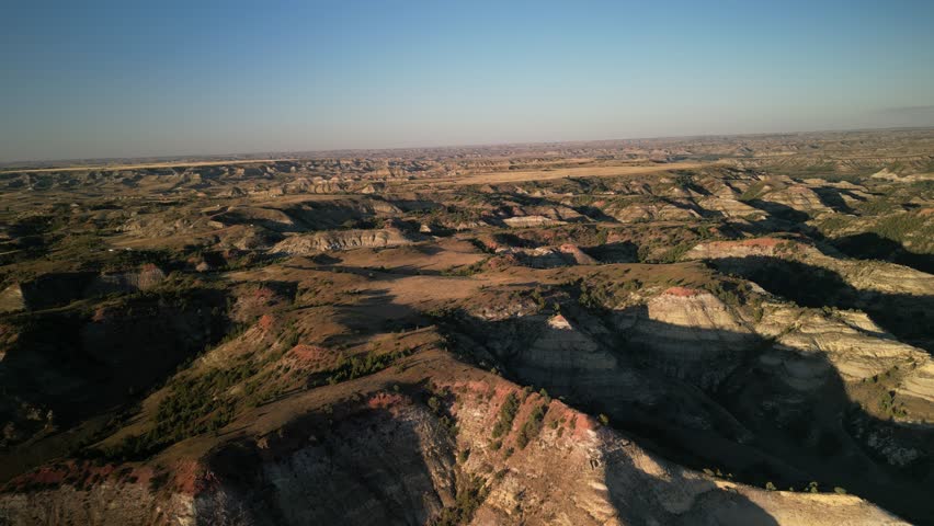 Aerial above colorful badlands in Medora North Dakota at sunset