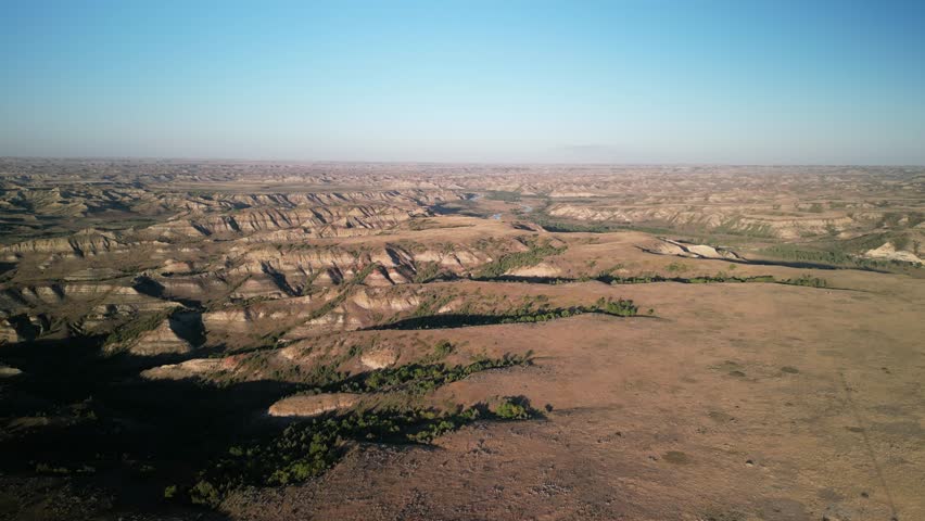 Aerial above Medora North Dakota badlands and Little Missouri River at sunset