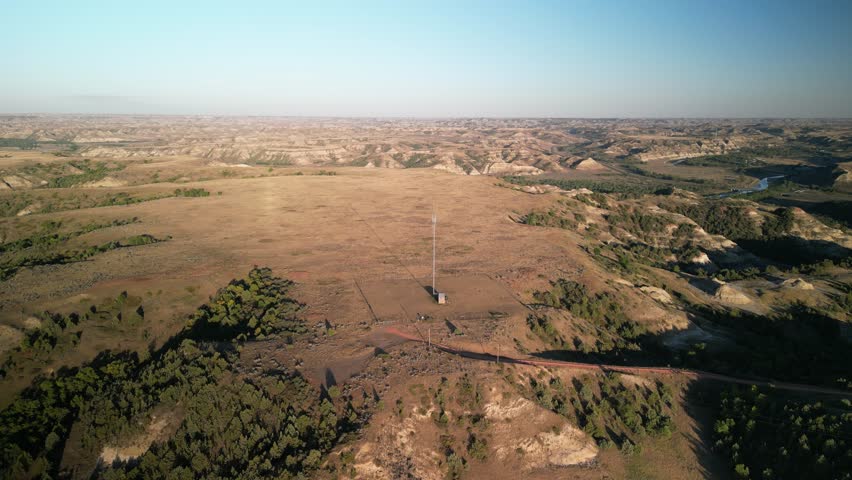 Aerial of cell tower in Medora North Dakota badlands at sunset