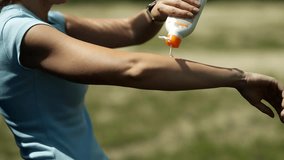 Woman Using Sunblock Lotion On Beach. Woman Applying Sunscreen Lotion On Body. Sunblock  Using Sun Block Cream Or Protective Moisturizer Before Sunbathing On Tanned Skin. Sunblock Lotion - Powered by Shutterstock - Get 15% off with code: PIKWIZARD15