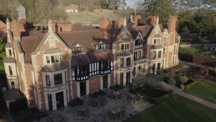 A horizontal panning shot of Wood Norton Hall and gardens,a Victorian mansion at in Worcestershire, England