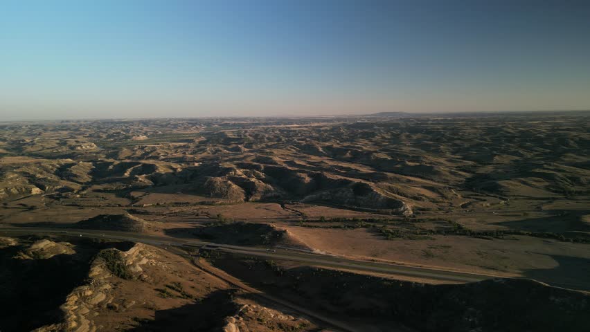 Aerial of Highway 94 through Medora North Dakota badlands at sunset
