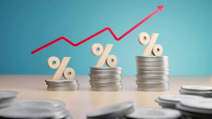 Wooden percentage signs on coin stacks with a rising red arrow, symbolizing increasing interest rates and financial growth.