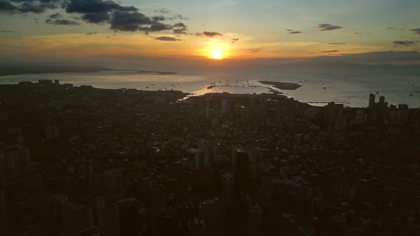 Aerial view of skyscrapers buildings in Makati business district and Manila city at sunset, capital of Philippines, timelapse 4k