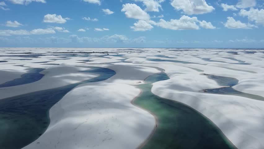 National Park, where vast white sand dunes stretch across the horizon, creating a surreal desert-like landscape. During the rainy season, the valleys between the dunes fill with crystal-clear.