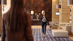 Beautiful host of a business conference welcoming her guest - Powered by Shutterstock - Get 15% off with code: PIKWIZARD15