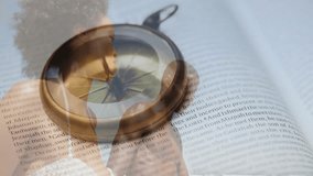 Animation of book and compass over african american couple on beach. Travel, vacation and digital interface concept digitally generated video. - Powered by Shutterstock - Get 15% off with code: PIKWIZARD15