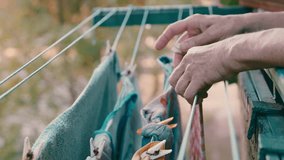 Sunlit Balcony Laundry: Senior Woman's Evening Ritual. Eco-Friendly Urban Living. Timeless Household Practices in Green Surroundings. Serene Moments of Elderly Independence - Powered by Shutterstock - Get 15% off with code: PIKWIZARD15