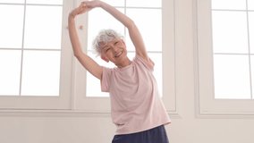 Asian senior sportswoman exercising indoor - Powered by Shutterstock - Get 15% off with code: PIKWIZARD15