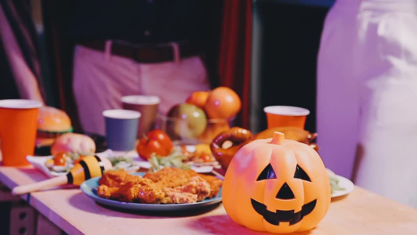 Four people dancing at a costume Halloween party in a house.
