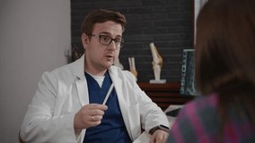 An osteopathic doctor consults a young woman. A man analyzes an MRI image to make a diagnosis for a patient. Reception after injury - Powered by Shutterstock - Get 15% off with code: PIKWIZARD15