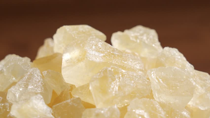 Yellow rock candy sugar crystals, Crystal Sweet Candy, circle rotation close up