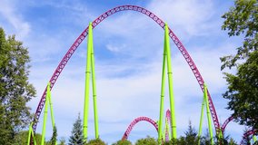 Roller coaster, trolleys up and down turn and the passing train of cars tends to shoot up and fall down rapidly in green trees bushes city park - Powered by Shutterstock - Get 15% off with code: PIKWIZARD15