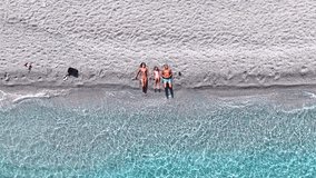 Summer holiday concept with a aerial rocket view of a family lying on a beautiful beach with turquoise sea, Sporades, Greece - Powered by Shutterstock - Get 15% off with code: PIKWIZARD15
